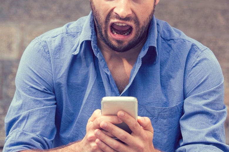 A man screams at his cellphone.